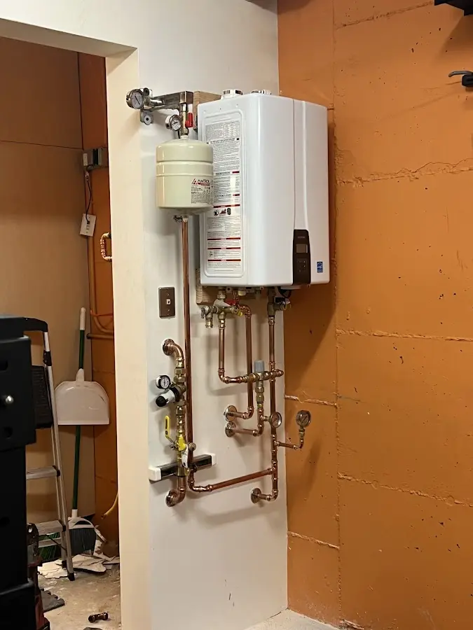 Plumbing technician inspecting water heater connections in Arcadia